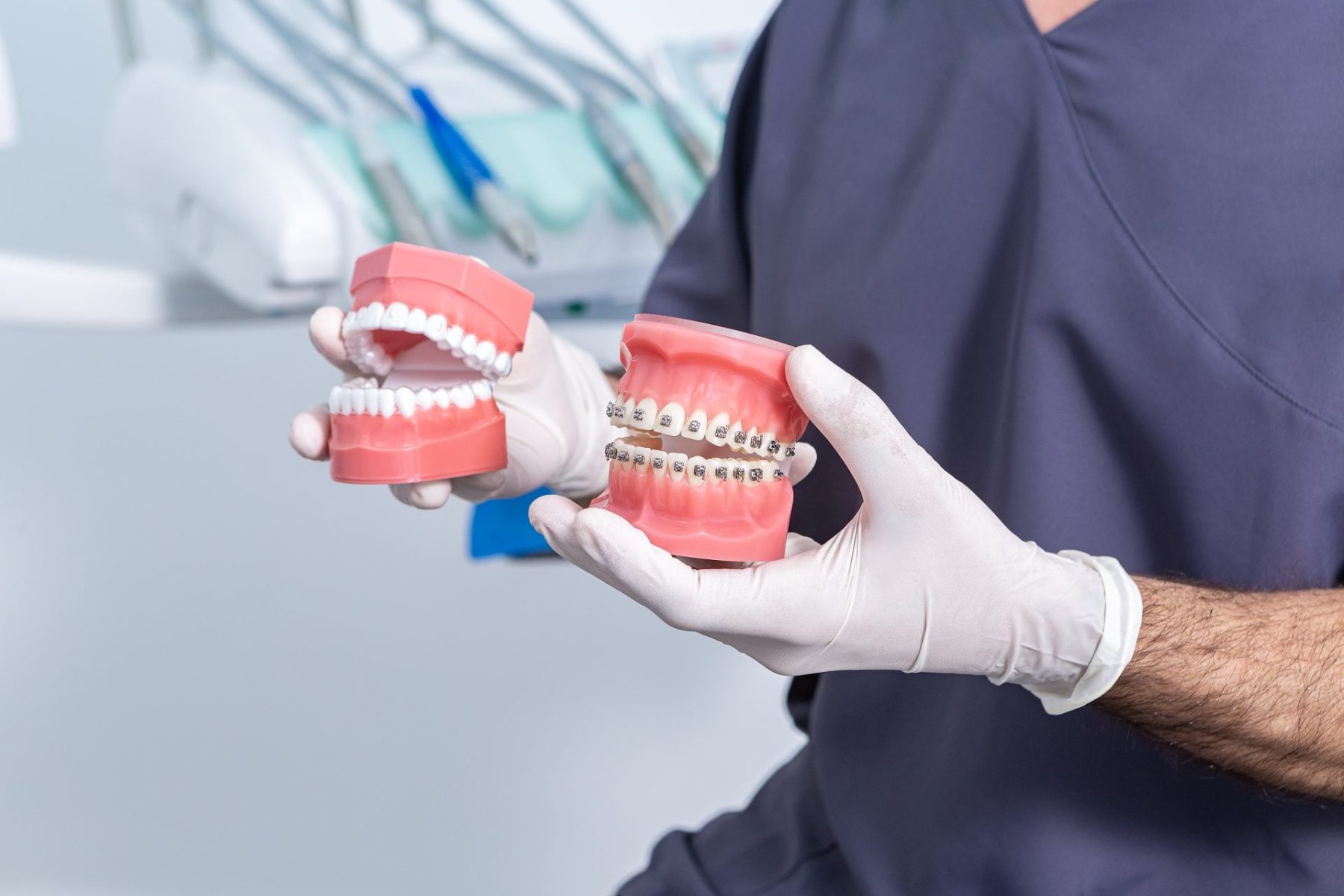 crop-anonymous-stomatologist-with-dentures-sitting-2023-11-27-05-23-37-utc