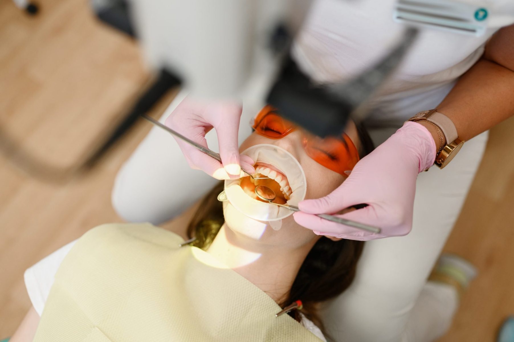 female-dentist-and-patient-with-opened-mouth-2023-11-27-05-25-45-utc